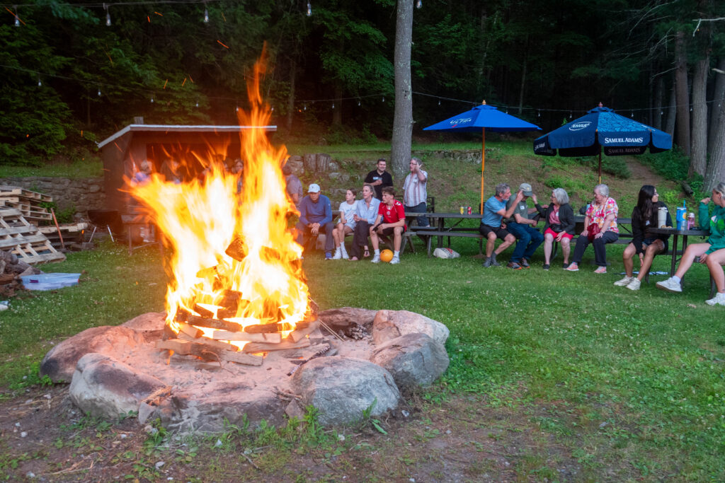 people sitting around a bonfire